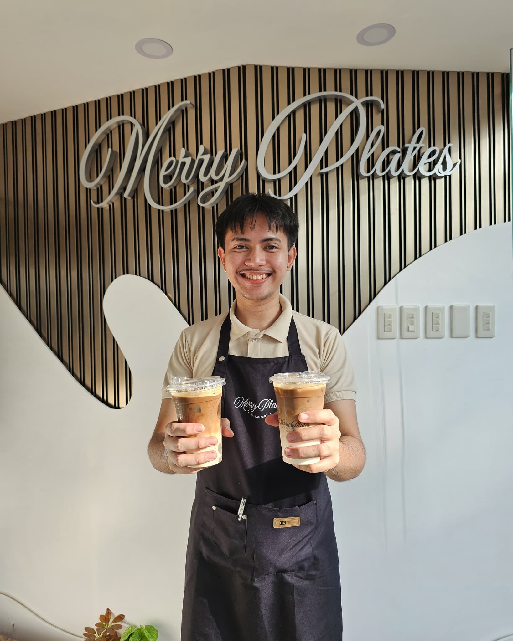 Merry Plates friendly staff holding coffees and smiling — warm Filipino hospitality at Highlights Taal Lakeview Resort Batangas