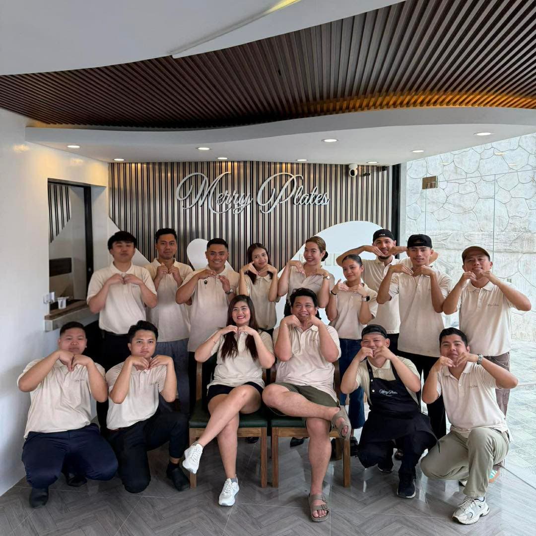 The full Merry Plates Restaurant team in front of the restaurant sign at Highlights Taal Lakeview Resort Batangas